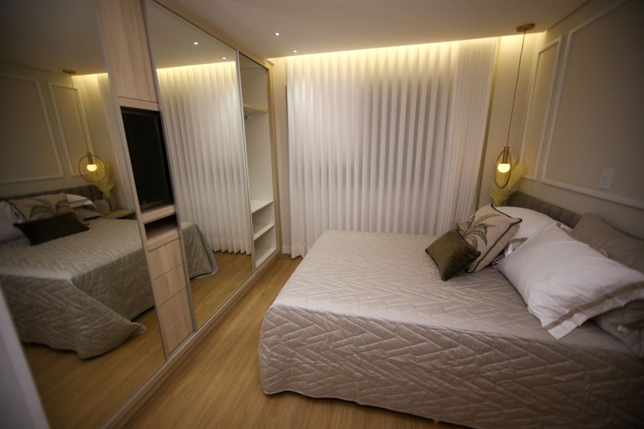 A cozy modern bedroom with elegant interior design and soft lighting.